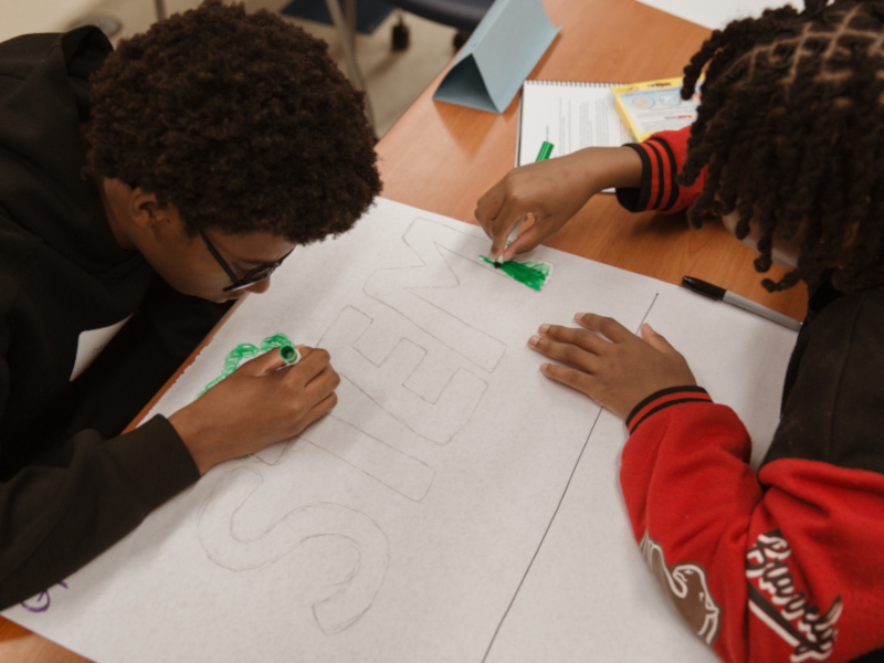 Students working on presentation board