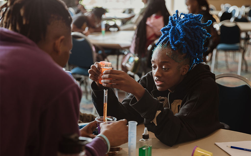 Students building reservoirs