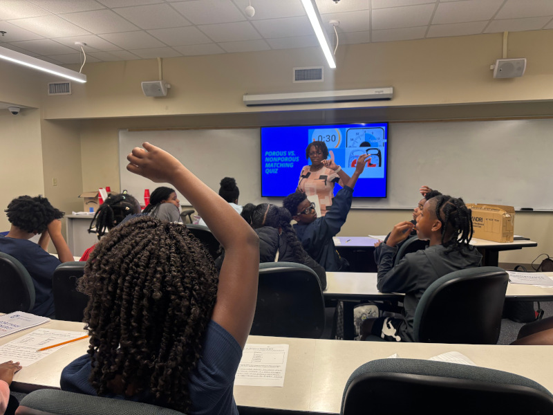 Student raising hand in class