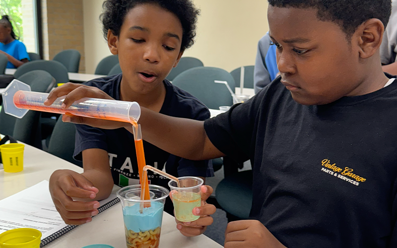 Students building reservoirs